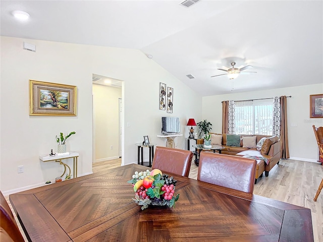 dining space featuring ceiling fan, vaulted ceiling, and light hardwood / wood-style floors