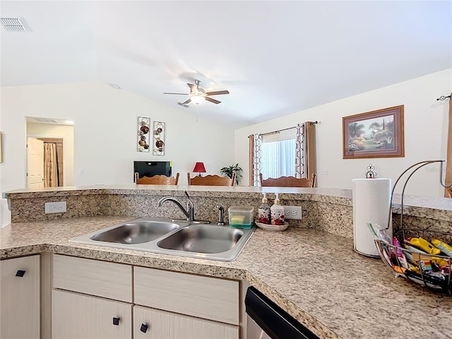 kitchen featuring dishwasher, ceiling fan, vaulted ceiling, and sink