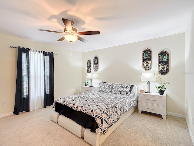 bedroom featuring ceiling fan and light carpet