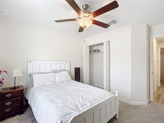 carpeted bedroom featuring ceiling fan and a closet