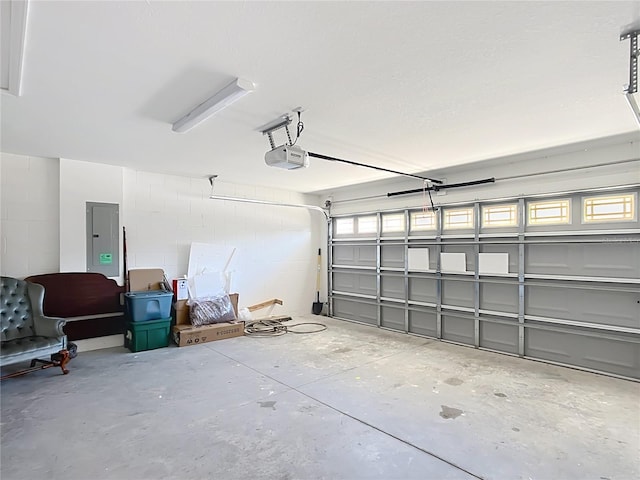 garage featuring a garage door opener and electric panel