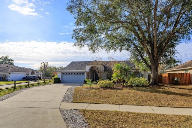 ranch-style house with a garage and a front yard