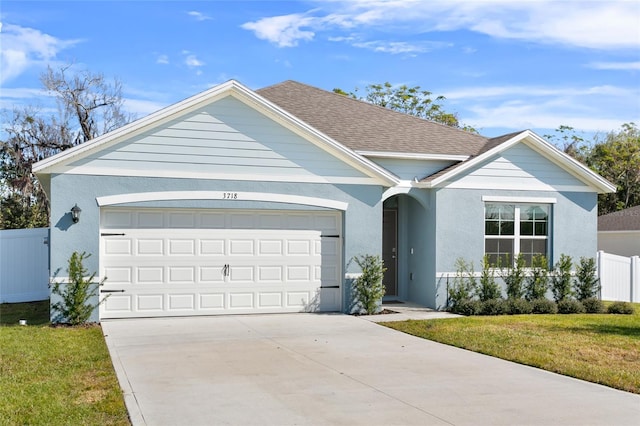 single story home with a front yard and a garage