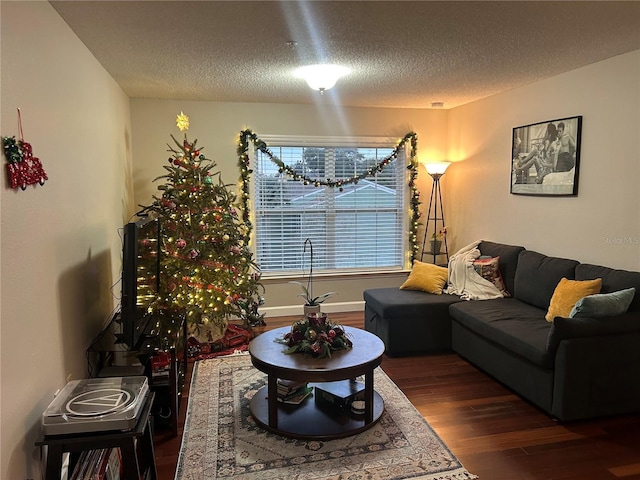 living room featuring a textured ceiling and dark hardwood / wood-style floors