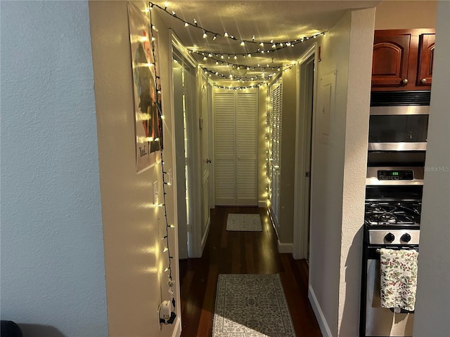 hallway with dark hardwood / wood-style flooring