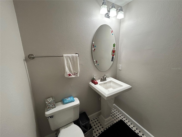 bathroom featuring tile patterned flooring and toilet