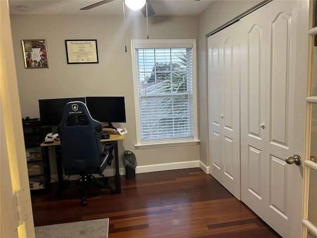 office with dark wood-type flooring and ceiling fan