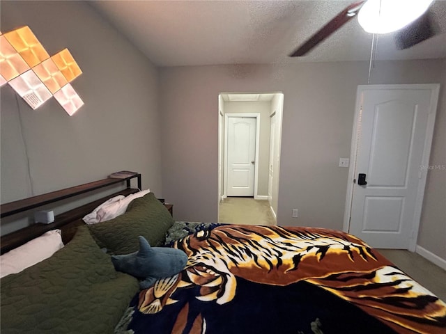 carpeted bedroom with a textured ceiling and ceiling fan