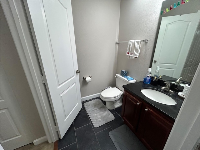 bathroom featuring toilet, tile patterned floors, and vanity