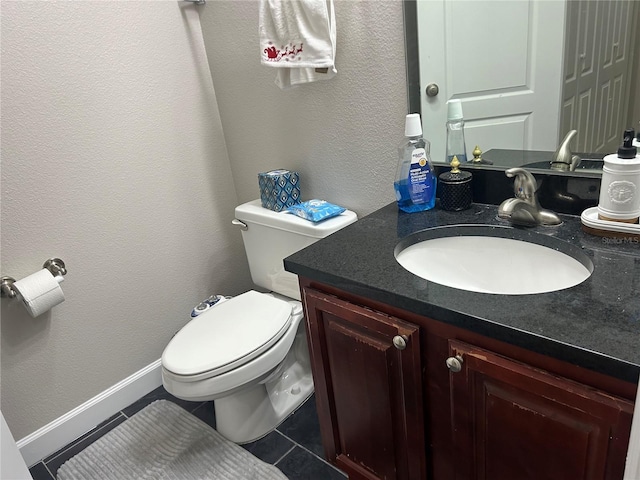 bathroom with vanity, tile patterned floors, and toilet