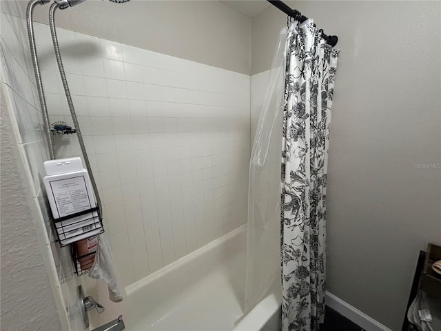 bathroom with shower / bath combo with shower curtain