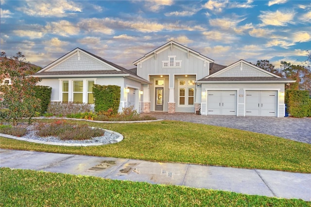 view of front of home with a lawn and a garage