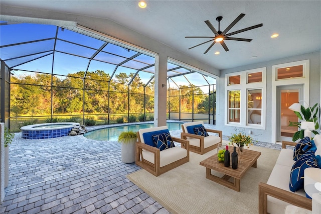 view of patio featuring a swimming pool with hot tub, an outdoor hangout area, glass enclosure, and ceiling fan