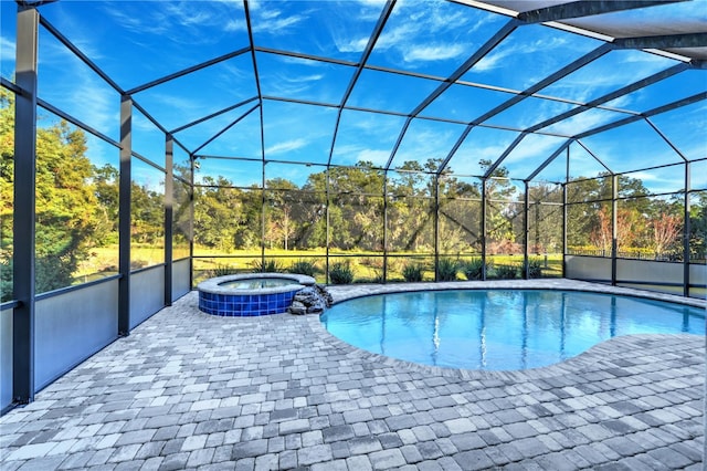 view of pool featuring glass enclosure and a patio area