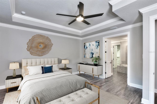 bedroom with hardwood / wood-style floors, ceiling fan, ornamental molding, and connected bathroom