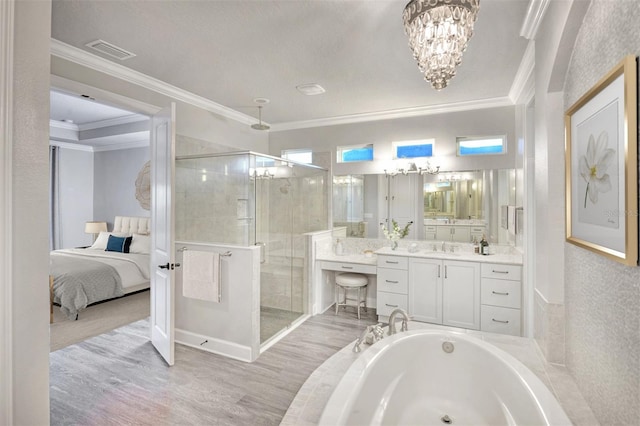 bathroom with ornamental molding, vanity, separate shower and tub, wood-type flooring, and an inviting chandelier