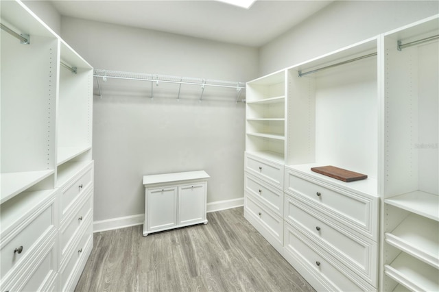 spacious closet with light hardwood / wood-style flooring