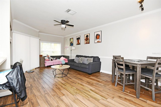 living room with ceiling fan, light hardwood / wood-style floors, and ornamental molding