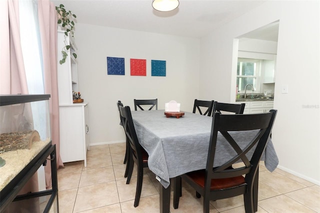 tiled dining space featuring sink