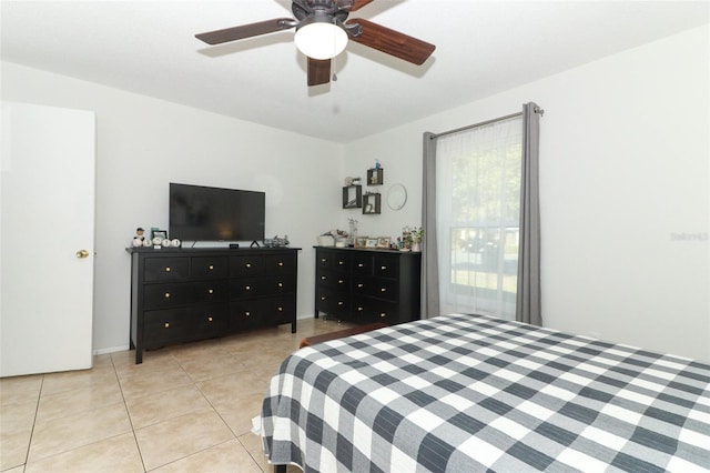 tiled bedroom featuring ceiling fan