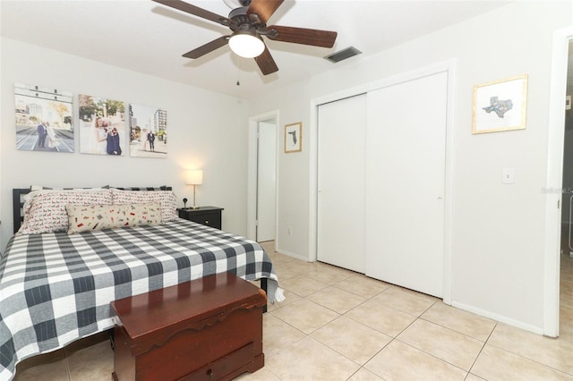 bedroom featuring a closet, ceiling fan, and light tile patterned flooring