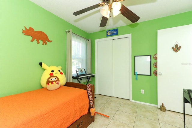 tiled bedroom featuring ceiling fan and a closet