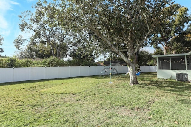 view of yard featuring central AC and a sunroom