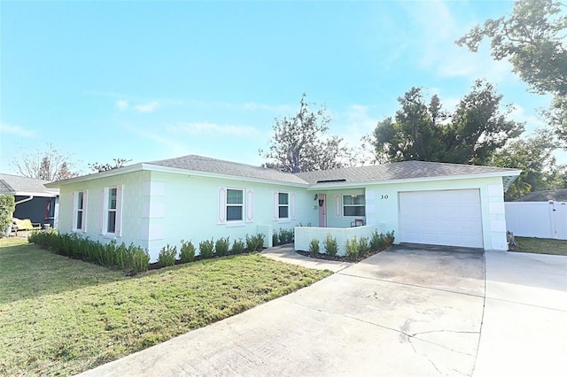 ranch-style home featuring a garage and a front yard