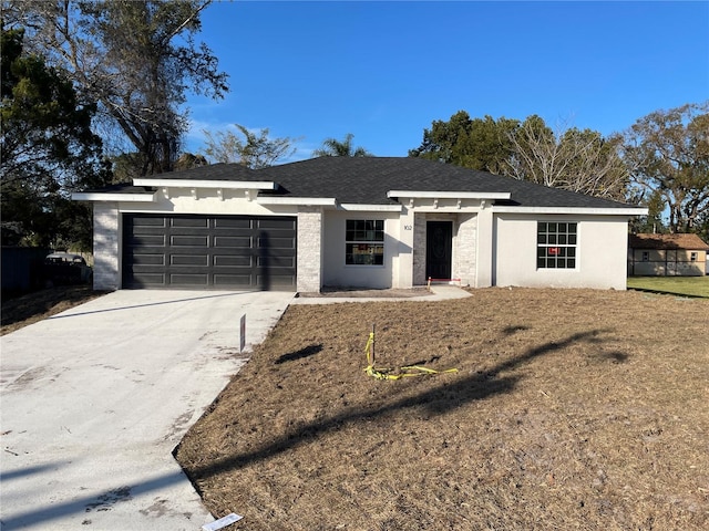 view of front of house with a front lawn and a garage