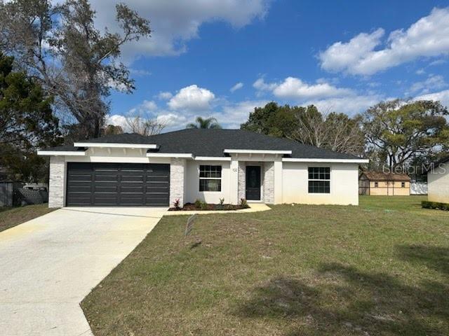 view of front of house with a garage and a front yard