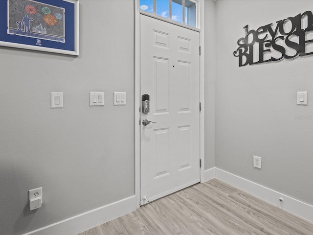 foyer entrance with light hardwood / wood-style flooring