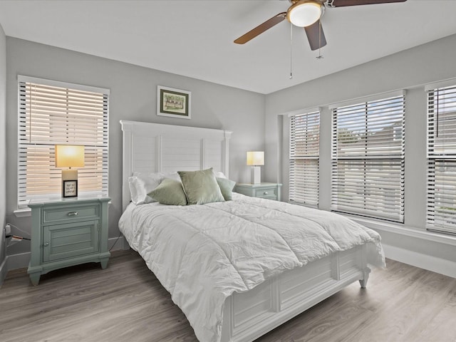 bedroom with ceiling fan and light hardwood / wood-style floors