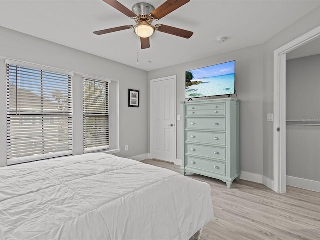 bedroom featuring light hardwood / wood-style floors, a closet, and ceiling fan