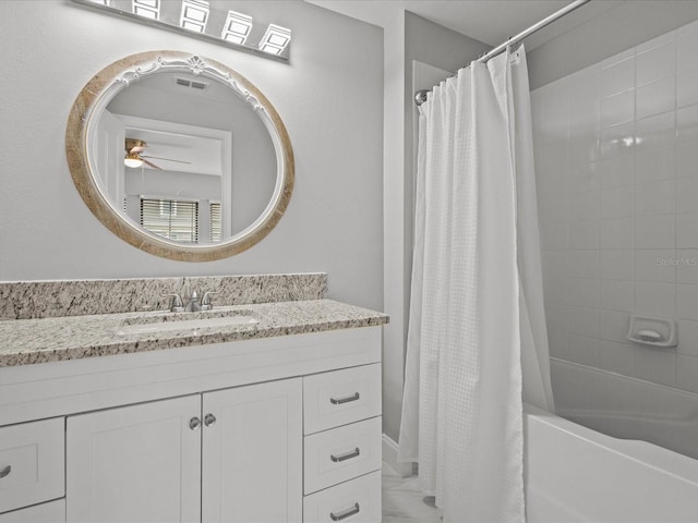 bathroom featuring vanity, ceiling fan, and shower / bath combo