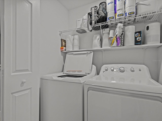 washroom with washing machine and clothes dryer