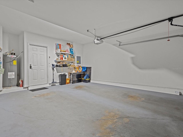 garage featuring electric panel, water heater, and a garage door opener