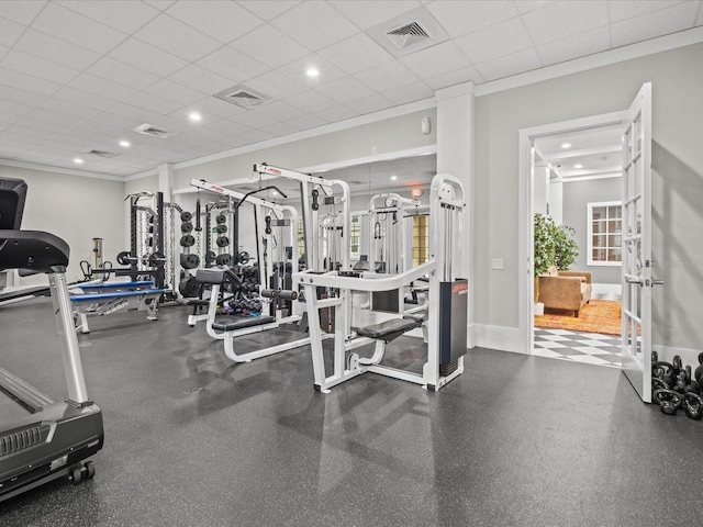 exercise room with a paneled ceiling and crown molding