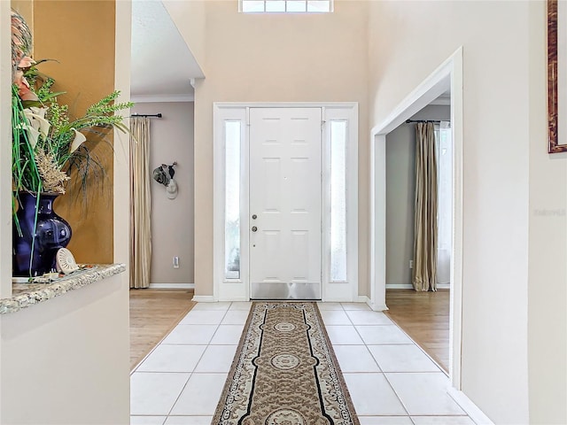 tiled entryway with ornamental molding