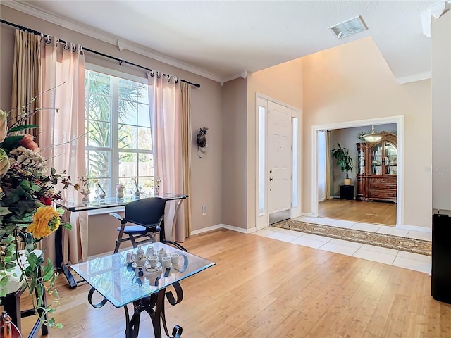 entryway featuring light hardwood / wood-style floors and crown molding