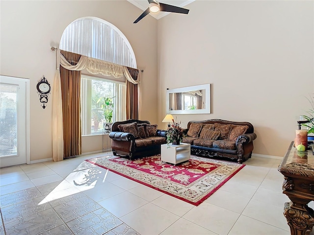 tiled living room with a high ceiling and ceiling fan