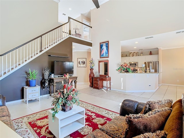 living room featuring light tile patterned flooring and a towering ceiling