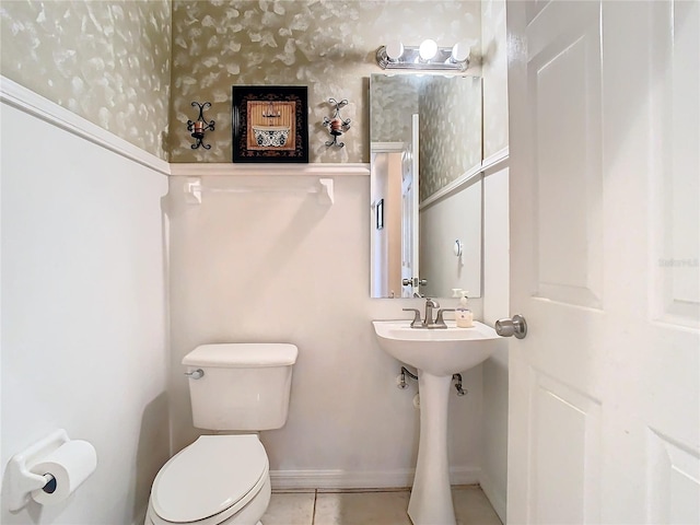 bathroom featuring toilet and tile patterned floors