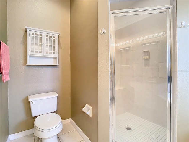 bathroom with toilet, a shower with door, and tile patterned floors