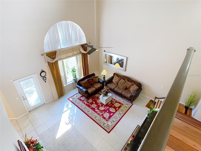 tiled living room with a towering ceiling