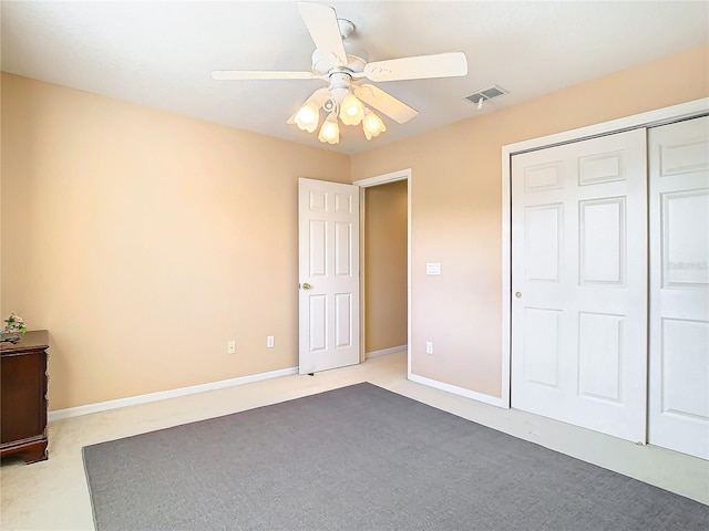 unfurnished bedroom with light carpet, a closet, and ceiling fan