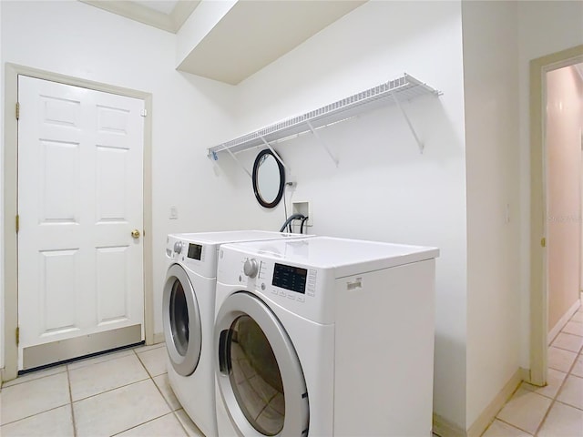 washroom featuring washer and dryer and light tile patterned flooring