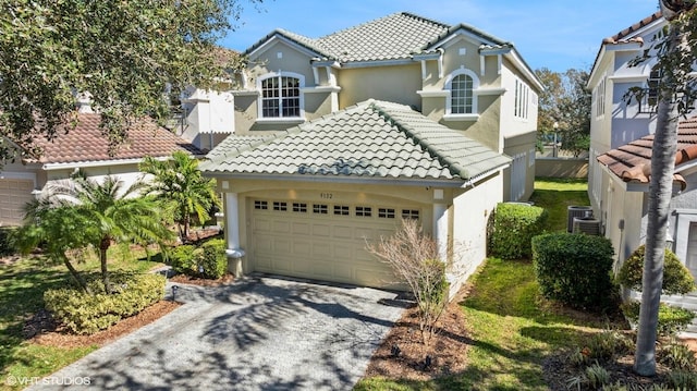 mediterranean / spanish-style house with a garage