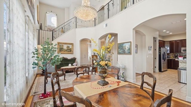 tiled dining area featuring an inviting chandelier