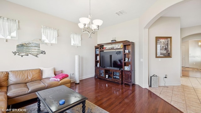 living room with hardwood / wood-style floors and a chandelier