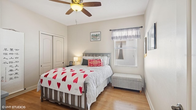 bedroom with hardwood / wood-style flooring, a closet, and ceiling fan